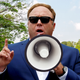 Illustration for article titled Alex Jones Returns To Humble Roots Of Screaming Conspiracy Theories Through Megaphone At People In Park